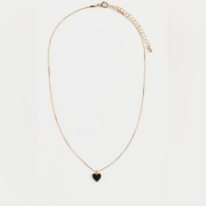 Gold necklace with black heart